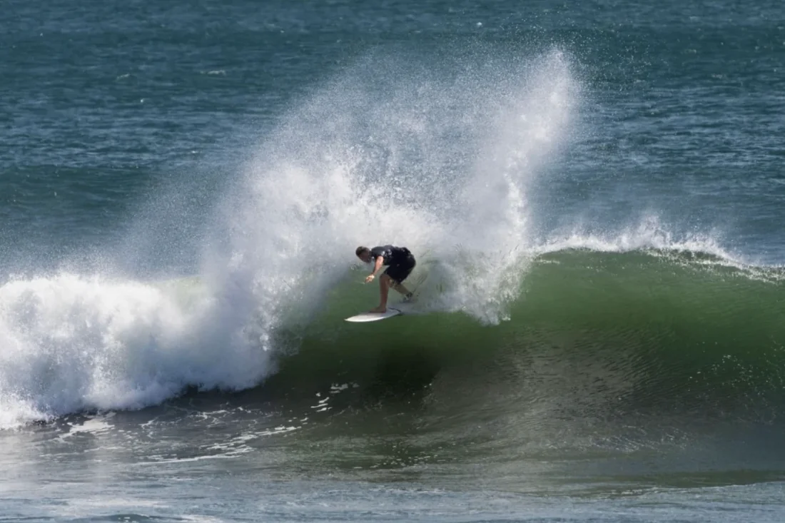 A surfer gets pitched in a big spray of whitewater